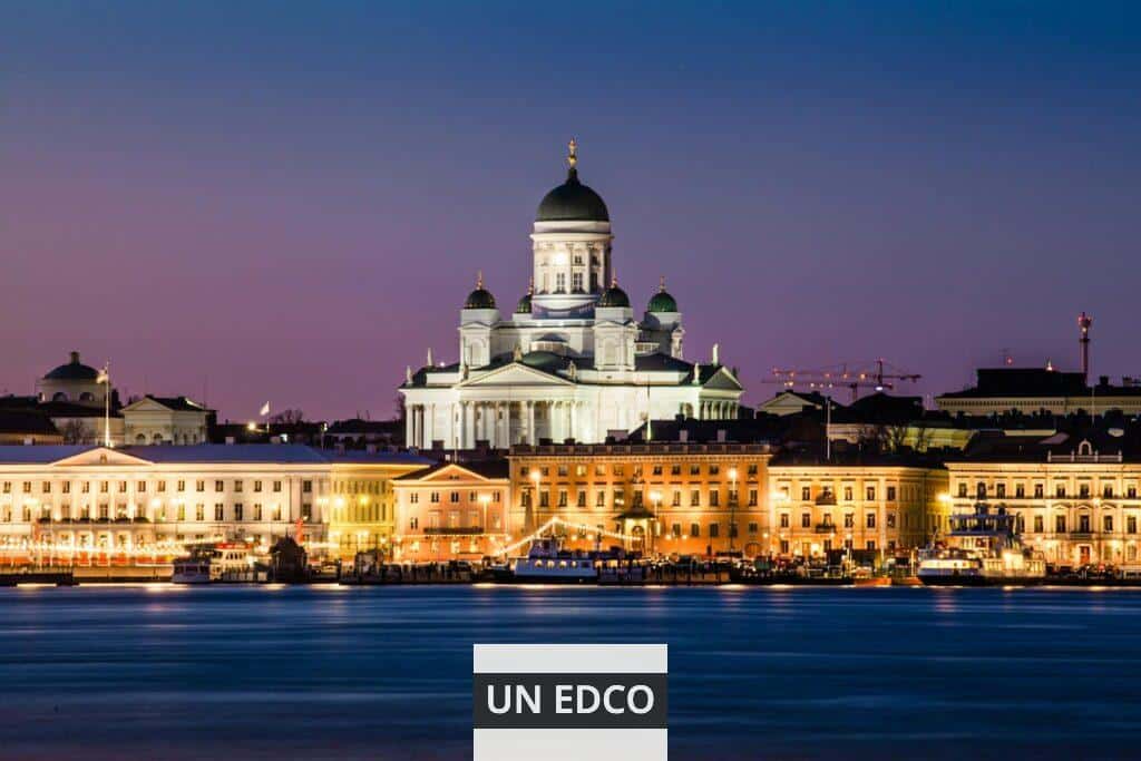 A stunning view of Helsinki Cathedral glowing at dusk with reflections on the water.