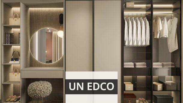 a walk in closet with a mirror and a stool